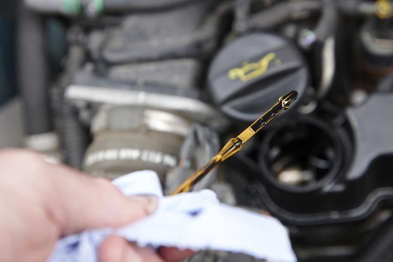 Use a dipstick to check the engine oil. Take Care of Your Car