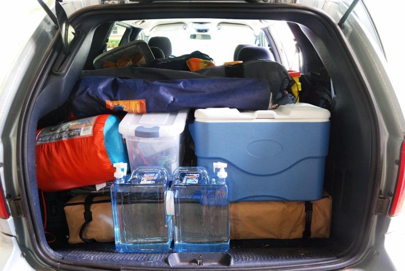 Pack small items in a large bin or basket. Clever Car Camping Hacks