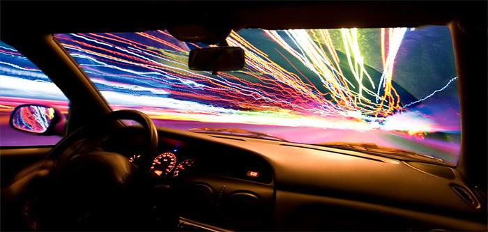 Light's color spectrum will be different. Would headlights work at light speed