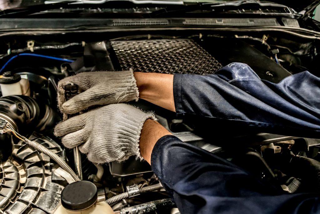 Professionals working on the engine Car cooling system