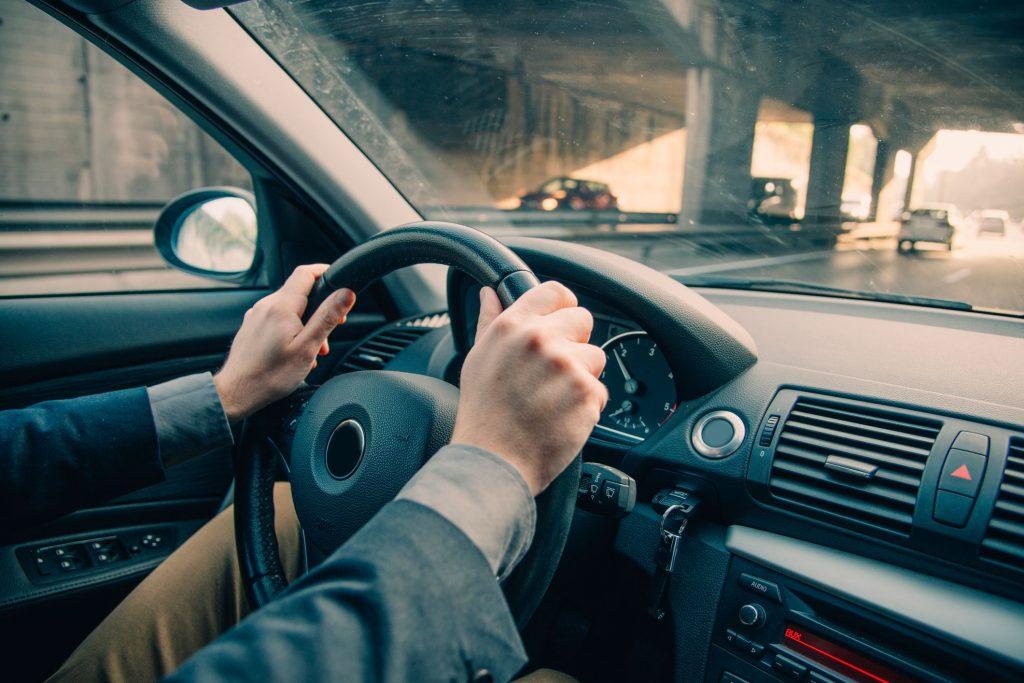 Man Holding Steering Wheel Suspension Bushings
